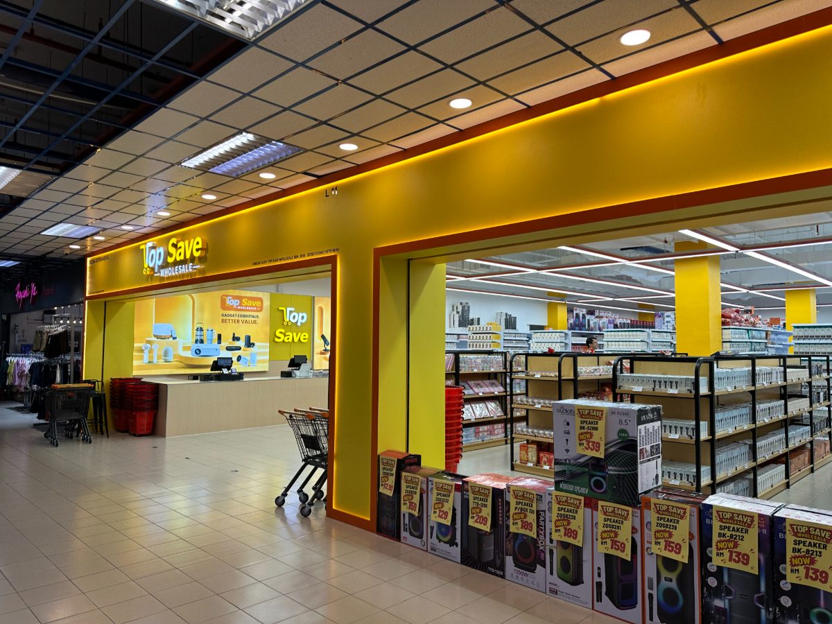 The Top Save Wholesale shop entrance, with trolleys by the door and stocked shelving inside